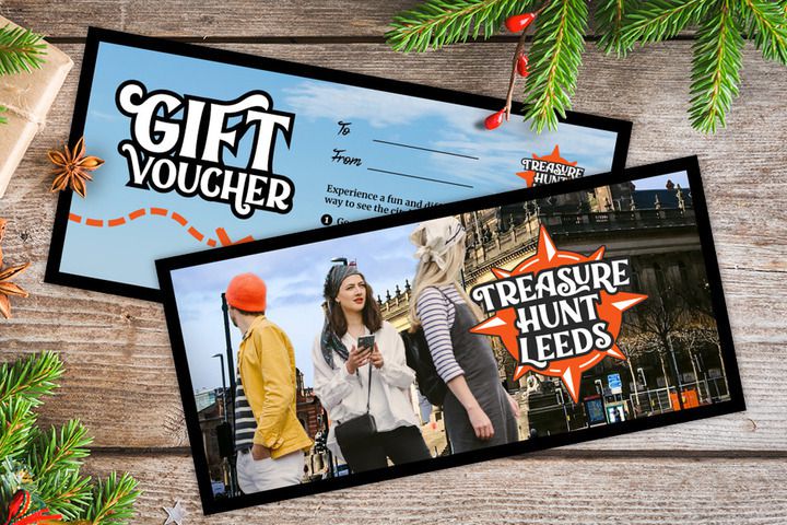 A gift voucher for Treasure Hunt Leeds on a table covered with Christmas decorations