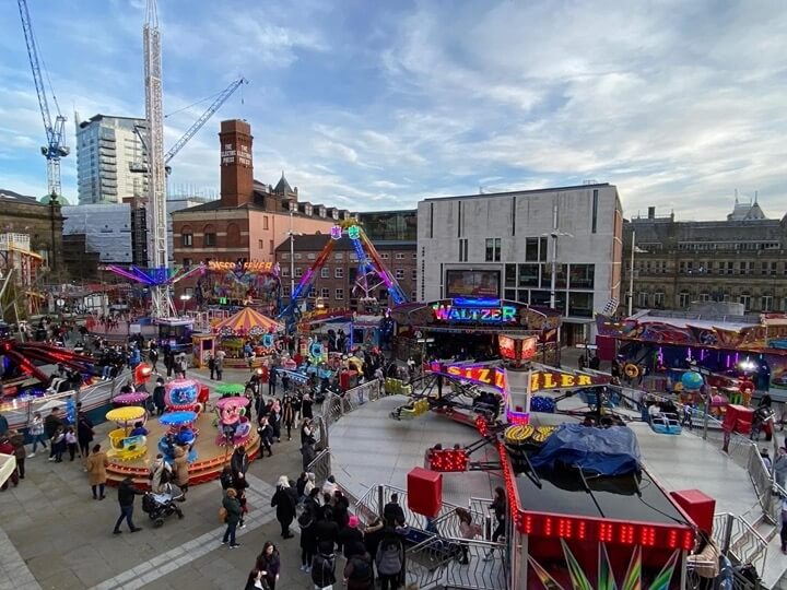 Leeds Valentine’s Fair with colourful amusement rides, stalls, and bustling crowds.